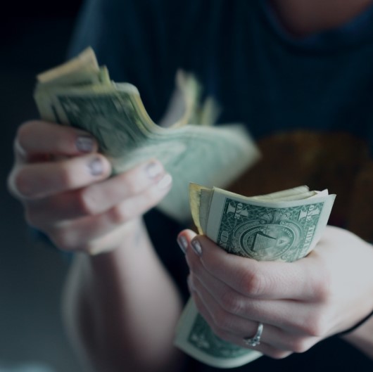 photo of lady worried about gas prices paying with cash