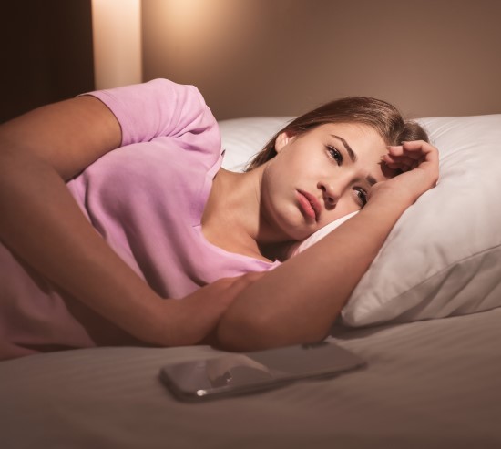 photo of sleepless teen student awake in bed