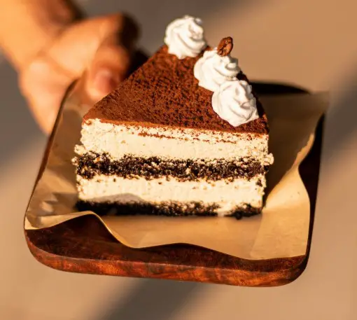 Tiramisu, a popular dessert loaded with caffeine from the coffee and chocolate photo of slice of tiramisu which is a dessert loaded with caffeine from the coffee and chocolate