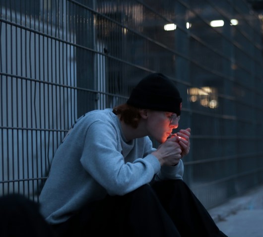 male smoking cigarette 530px photo of depressed teen siting by road
