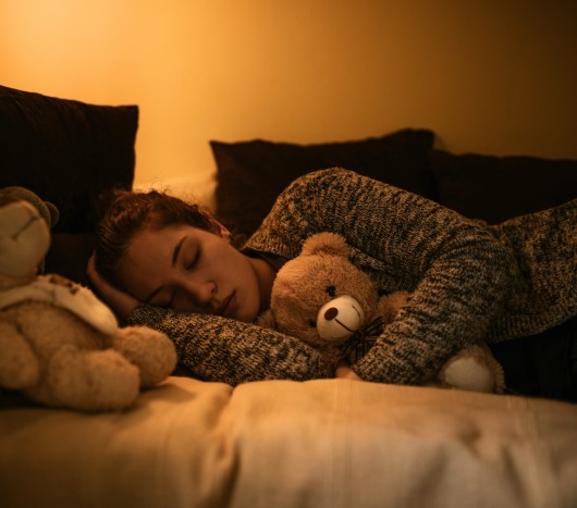 photo of female teen asleep in bed 