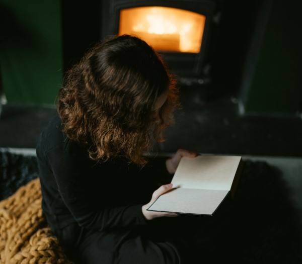 photo of teen reading a book at bedtime which is one of things that can help them sleep better