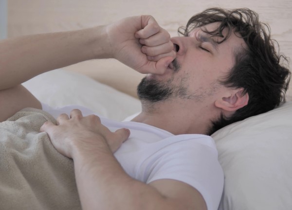 CPAP making a cold worse is pretty frustrating... photo of sick man in bed not using CPAP because of cold