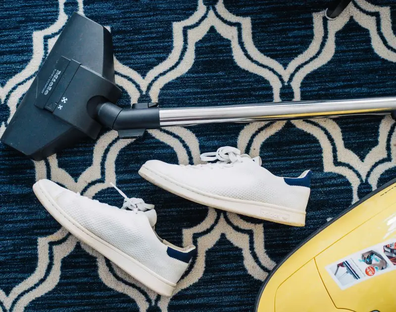 A clean clutter free room may help photo of shoes and vacuum cleaner on carpet