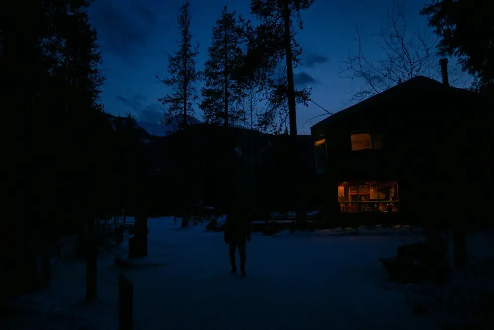 picture showing a partially lit house on a dark winter morning
